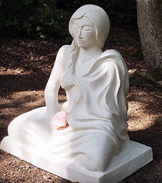 Kneeling Down, a seated pale figurative stone sculpture